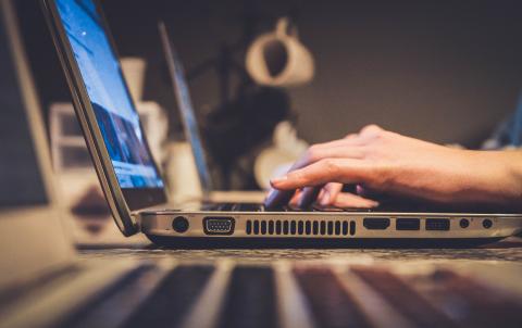 Computer with hands typing