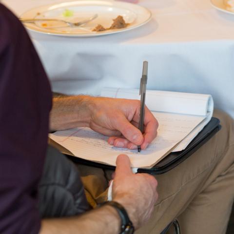 Man writing on note pad
