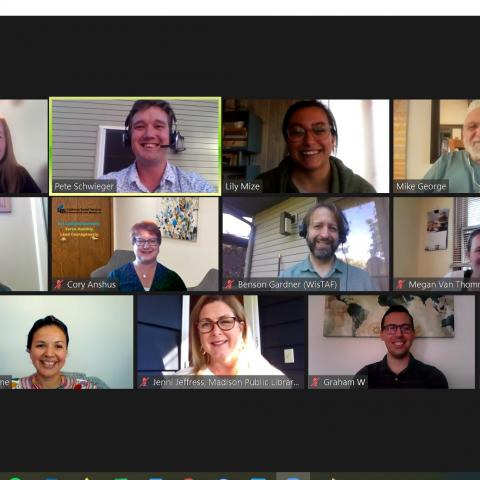 Zoom meeting with multiple smiling faces.