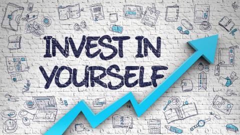 Text reads "Invest in Yourself" and the background is various books and papers on a off-white background. A blue arrow climbs across the bottom left of the graphic.