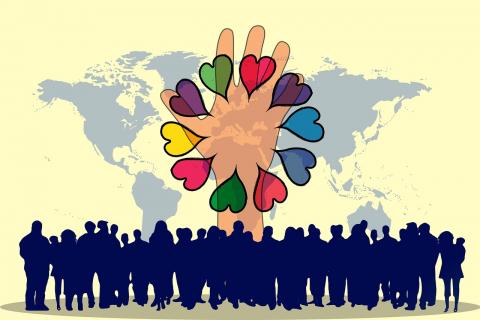 A yellow background with a world map. Along the bottom is a blue image of human figures. A tan hand is the center of the image with a variety of colorful hearts.